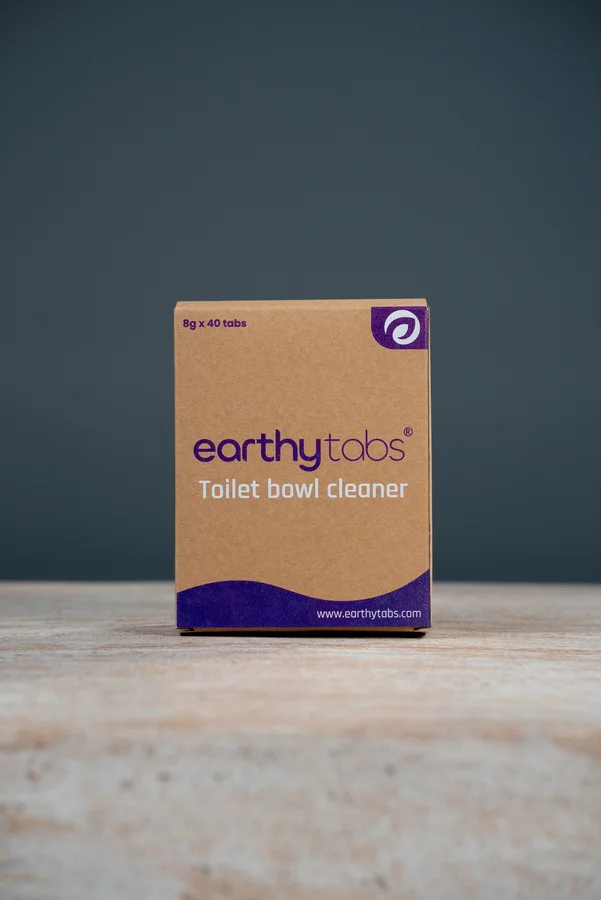 Tablet dropping into toilet bowl